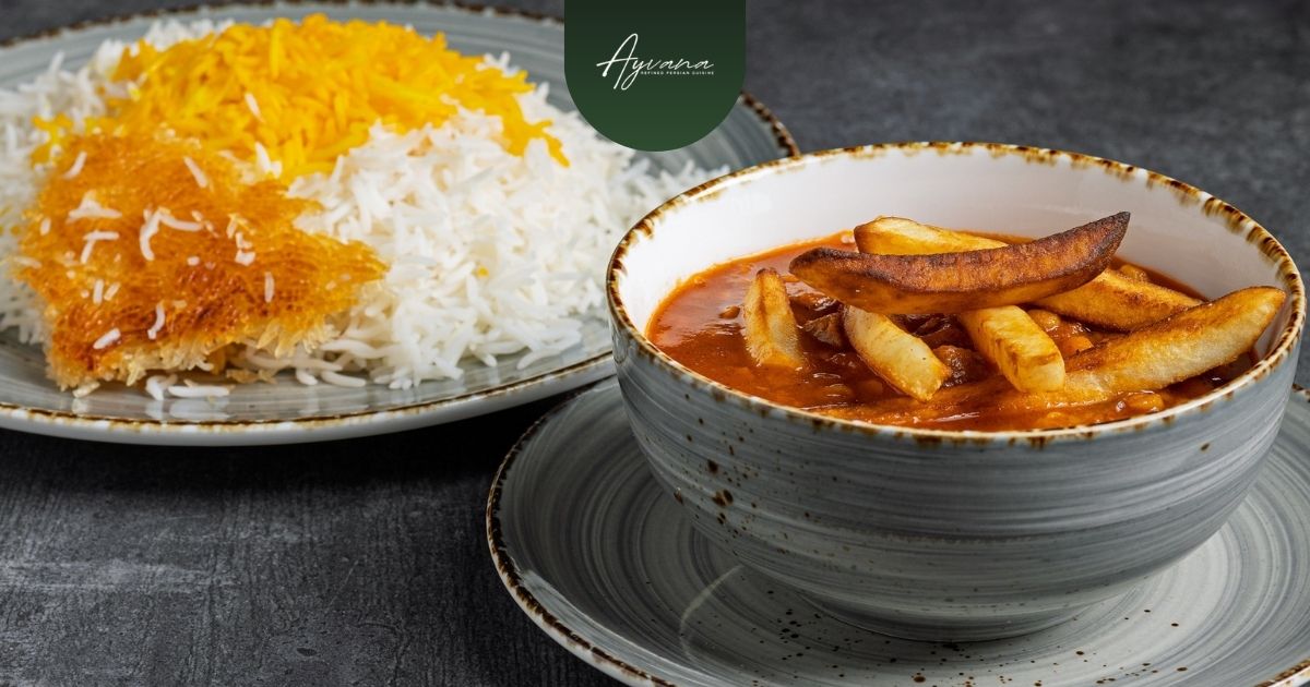 Persian tahdig served with crispy fries beside fluffy saffron rice and stew on dark restaurant table backdrop