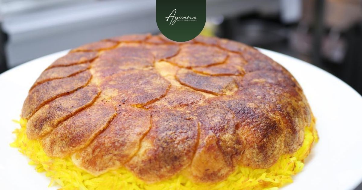 Crispy golden potato tahdig crust atop vibrant saffron rice, a classic Persian delicacy beautifully presented on a white plate at Ayvana.