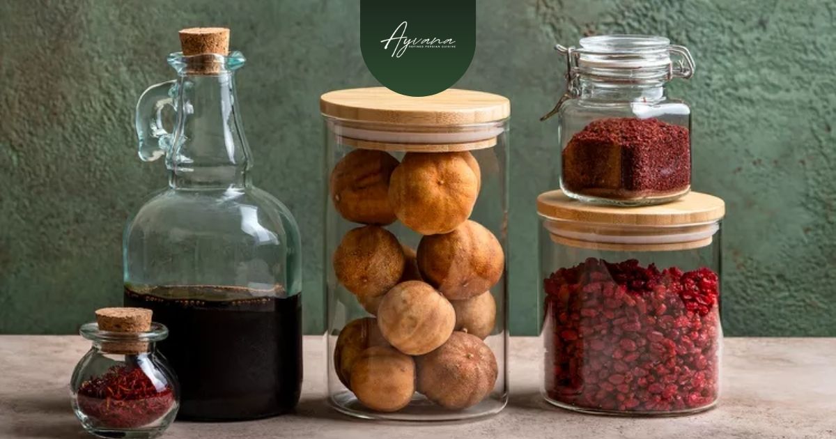Collection of essential Persian spices including saffron, dried limes, sumac arranged in elegant glass containers