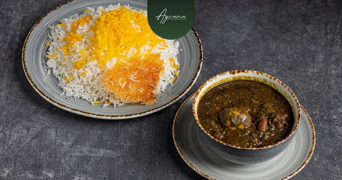 Traditional Ghormeh Sabzi herb stew served beside Persian saffron rice with crispy tahdig on rustic ceramic plates.