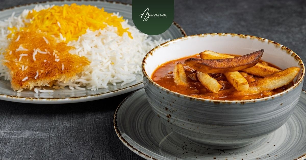 Traditional Persian Gheymeh stew topped with crispy fries served beside saffron rice and golden tahdig crust.