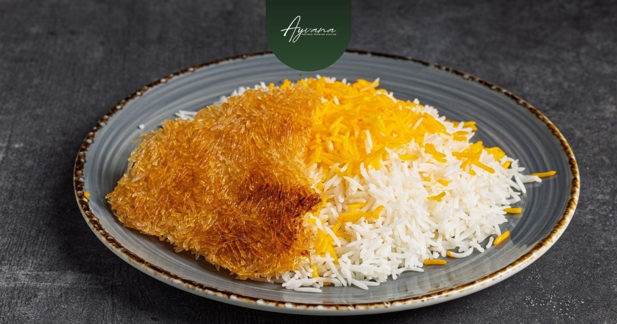 Persian saffron rice and tahdig served on a shared platter for family-style dining