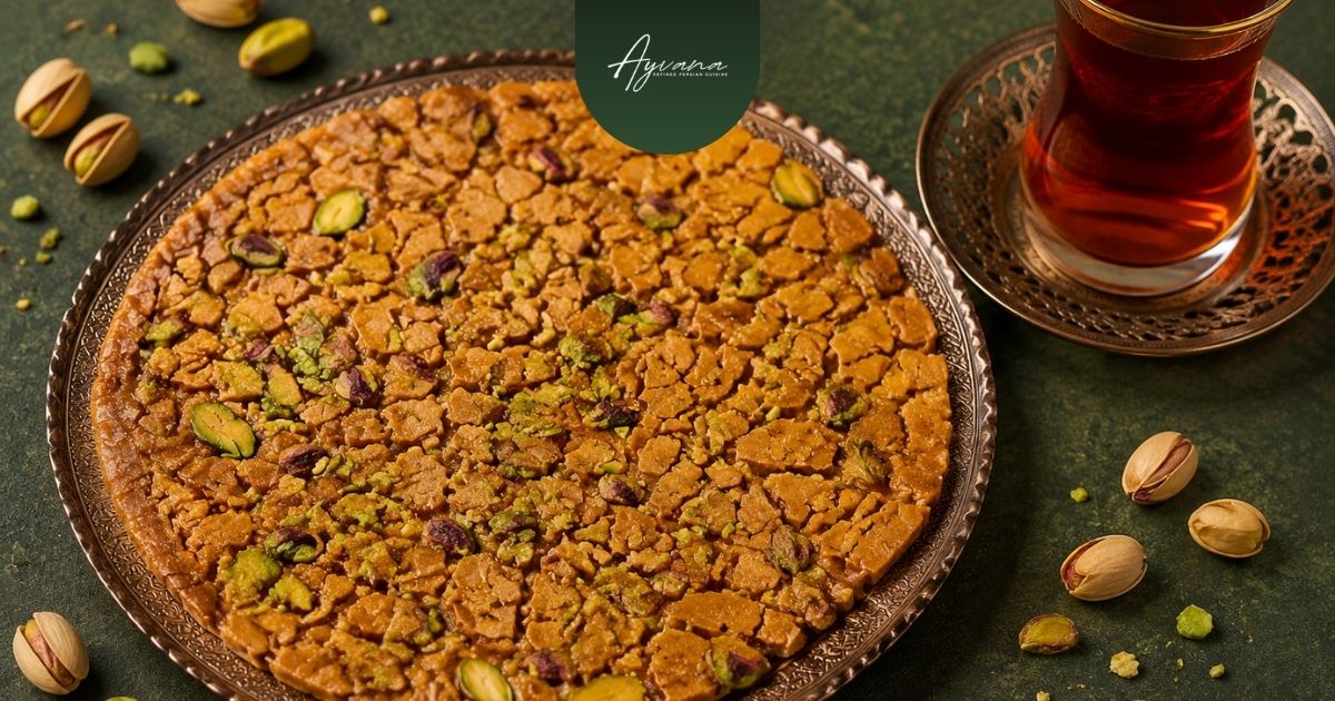 Traditional Persian sohan topped with pistachios and served alongside Persian tea